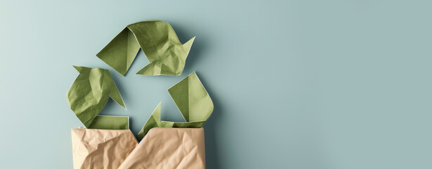 Obraz premium Crumpled Paper Recycling Symbol