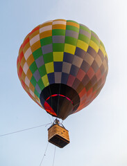 A colorful hot air balloon with a basket attached to it