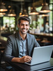 Fototapeta premium Man working in coffee shop on laptop.