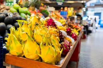 Juicy ripe dragon fruit pitaya at food market stall in Valencia