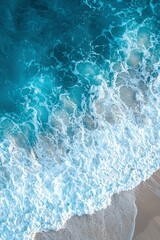 Fototapeta premium Aerial View of Ocean Waves Breaking on Sandy Shore