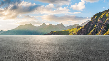 Asphalt road square and green mountain with sky clouds natural landscape at sunset. car background.