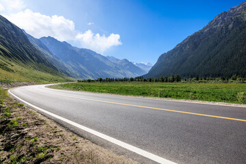Naklejka premium Asphalt highway road and green mountain nature landscape under blue sky. Road trip.