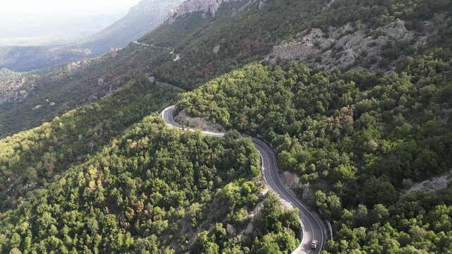 Beaufitul scenic aerial shot following the famous SS 125 road through the mountains in Sardinia, Italy.