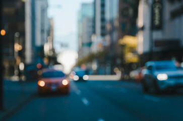 Blurred cityscape at dusk with soft focus of tall buildings, street and cars