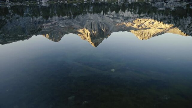 Mountain reflection in the clear waters of Rae Lakes along the John Muir Trail at sunrise