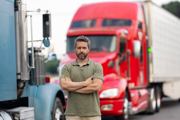 Trucking owner. Transportation vehicles. Hispanic man posing in front of truck. Semi trucks...
