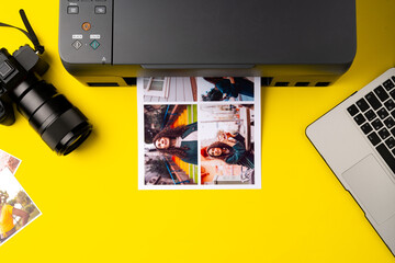 Printer printing colorful photos of people close up, yellow background