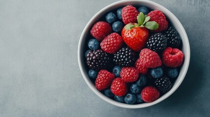 A colorful bowl filled with fresh berries, including strawberries, raspberries, and blueberries, perfect for healthy eating.