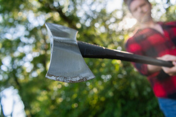 Lumberjack style. Man with axe blade. Axe in man hand chopping wood. Cutting wood. Sharp blade....