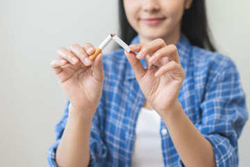 Quit, stop smoking, addiction asian young woman, girl refusing cigarette, smoker quitting smoke, hand in broken, break tobacco. Quit bad habit, health care concept. Willpower lifestyle of people.