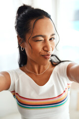 Woman, portrait and wink selfie for profile picture, vlog or social media post at home. Happy,...