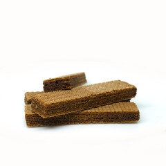 Chocolate wafer biscuits arranged crosswise on a white background