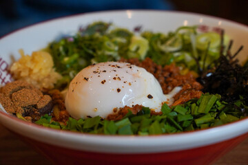 Japanese food mixed with vegetables, eggs, and a generous sauce