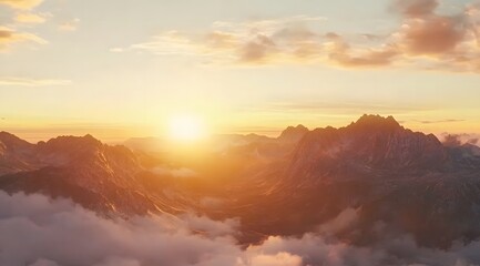 Obraz premium beautiful sunrise over mountains with misty clouds in the background