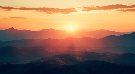 Obraz premium beautiful sunrise over mountains with misty clouds in the background