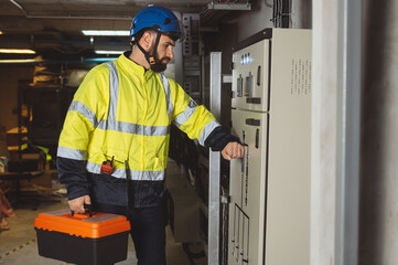 engineering technician Setting up the solar panel inverter in the electrical room Service engineer installs solar cells on factory roofs Concept of clean energy and renewable energy