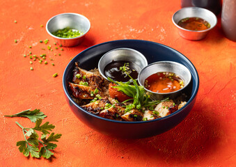 Hickory Bbq Pork Belly Rice Bowl with Sauce, and Green Onion isolated orange background side view of fast food