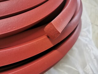 Red silicone seal mixed with sponge, Engineering machinery spare parts. Silicone rubber material for Seal or covering the door and the lid of a large boiler in industrial production. Illustration