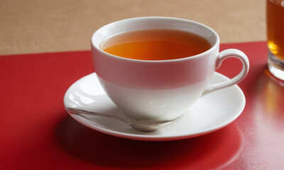 White Ceramic Mug on Red and Beige Background: Bold and Elegant