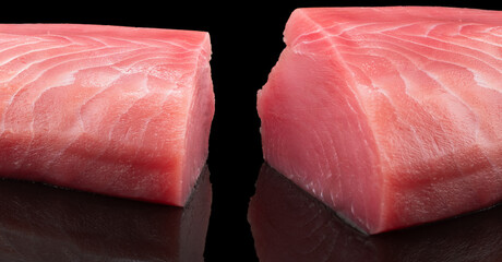 Yellow fin tuna steak isolated on black background. Fresh rare tuna steak isolated. Raw yellowfin...