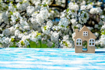 The symbol of the house stands against a background of cherry blossoms
