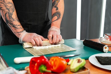 Preparing sushi rolls with fresh ingredients at a culinary studio