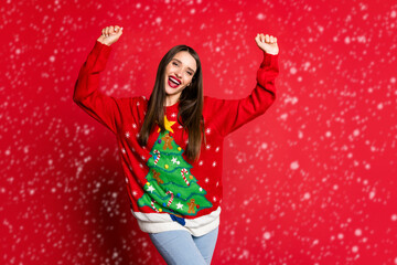 Photo of happy cheerful victorious young woman raise hands good mood win isolated on red color background