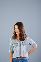 Obraz premium Happy, mockup space and woman in studio with confidence, pride and trendy fashion for college. University student, smile and isolated person for education, learning and studying on gray background