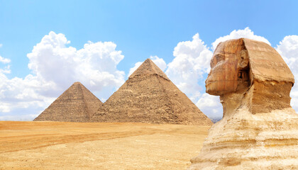 Famous Great Sphinx and pyramids of Chephren and Cheops, Cairo, Egypt. Great Pyramids and ancient statue of Sphinx, mythical creature with head of man and body of lion, Giza complex (Giza Necropolis)