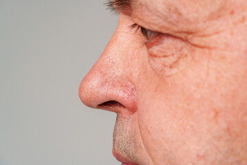Fototapeta premium Portrait of a mature man with short hair and a neutral expression, captured in a studio setting