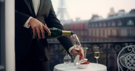 Anonymous Waiter Elegantly Pours Champagne on a Parisian Balcony, Overlooking the Eiffel Tower, Creating a Luxurious and Romantic Ambiance With Strawberries and a Rose on the Table