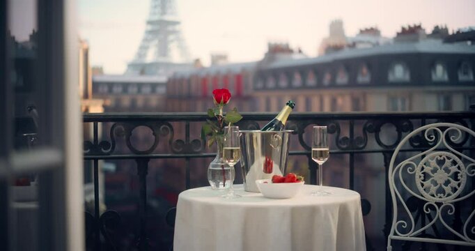 Parisian Hotel Balcony Features a Table Set with Champagne, Strawberries, and a Single Rose. Retreat Room Offering a Picturesque View of the Eiffel Tower, Perfect for a Romantic Summer Escape