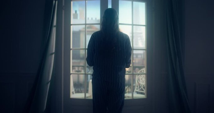 Wearing Cozy Pajamas, Female Draws Back the Curtains and Pushes Open the Balcony Doors, Inviting the Cool Morning Breeze Inside. She Steps Out, Admiring the Beautiful Eiffel Tower in the Distance