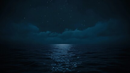 A serene night scene of a calm ocean under a starry sky with soft clouds.