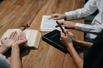  People reading and study bible in home and pray together.Studying the Word Of God
