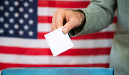 usa elections the hand of voter putting her vote in the ballot box