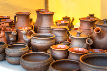 Traditional Russian Pottery. Clay Cups, Jugs, Plates, and Bowls on a Craftsmans Stall.