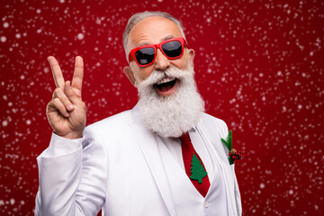 Photo of cheerful old cool man make v-sign good mood wear tree tie xmas isolated on red color background