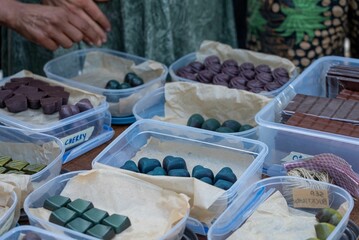Assorted handmade chocolates at a market stall.