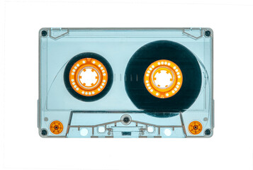 used transparent vintage audio tape cassette isolated, with the back light, a symbol of 80s, 90s period