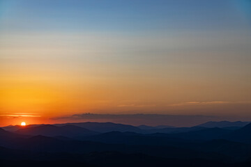 Sunset on the top of the mountain, mountain peaks on the background of the mountain landscape.