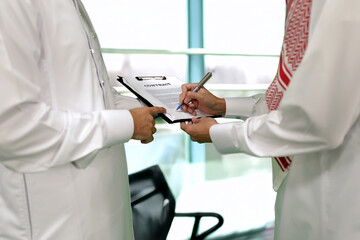 Arab man sign document in the office