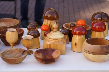 table with wooden vintage mushroom figurines with tableware made of natural materials close-up