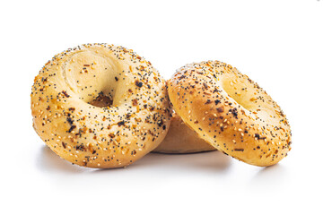 Bagel sprinkled with fried onion, sesame and poppy seeds isolated on white background.