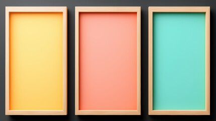 Fototapeta premium Three wooden-framed images with pastel-colored backgrounds: yellow, coral, and teal, set against a dark surface.