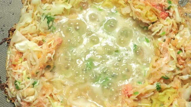Monjayaki, a traditional Japanese dish similar to okonomiyaki, cooked with flour, water, cabbage, and seafood as ingredients