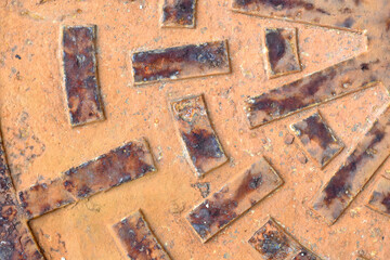 Rusty metal circle manhole cover close up shot