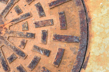Rusty metal circle manhole cover close up shot
