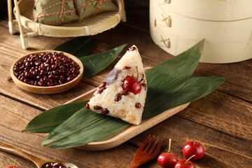 Traditional Chinese rice dumplings placed on a wooden table with hawthorn berry and red bean fillings